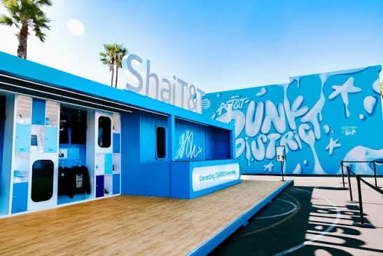 The AT&T storefront and Dunk District mural under a clear Miami sky