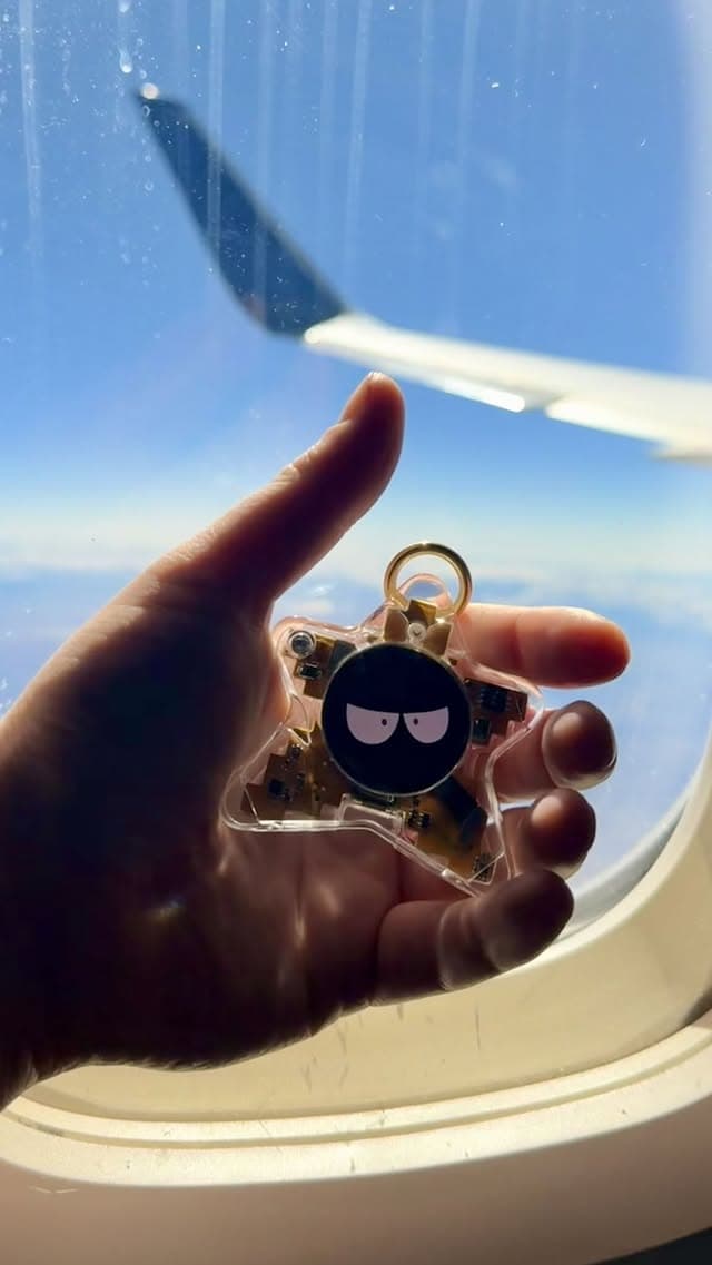 Oneira development prototype held in front of an airplane window